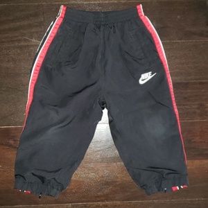 BOY'S NIKE SPORTS TRACK PANTS IN BLACK AND RED